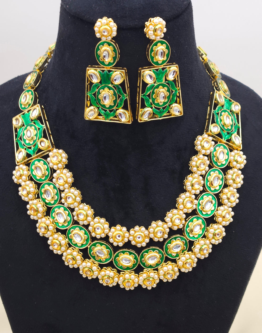 Royal-inspired Polki Kundan-Meena jewelry set in antique gold plating, adorned with lustrous pearls and intricate hand-enameled accents
