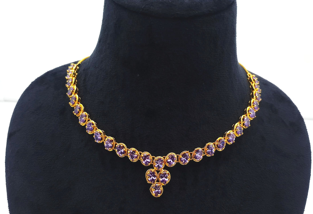 Close-up of antique gold plated statement necklace with faceted purple hydro quartz stones for elegant festive wear
