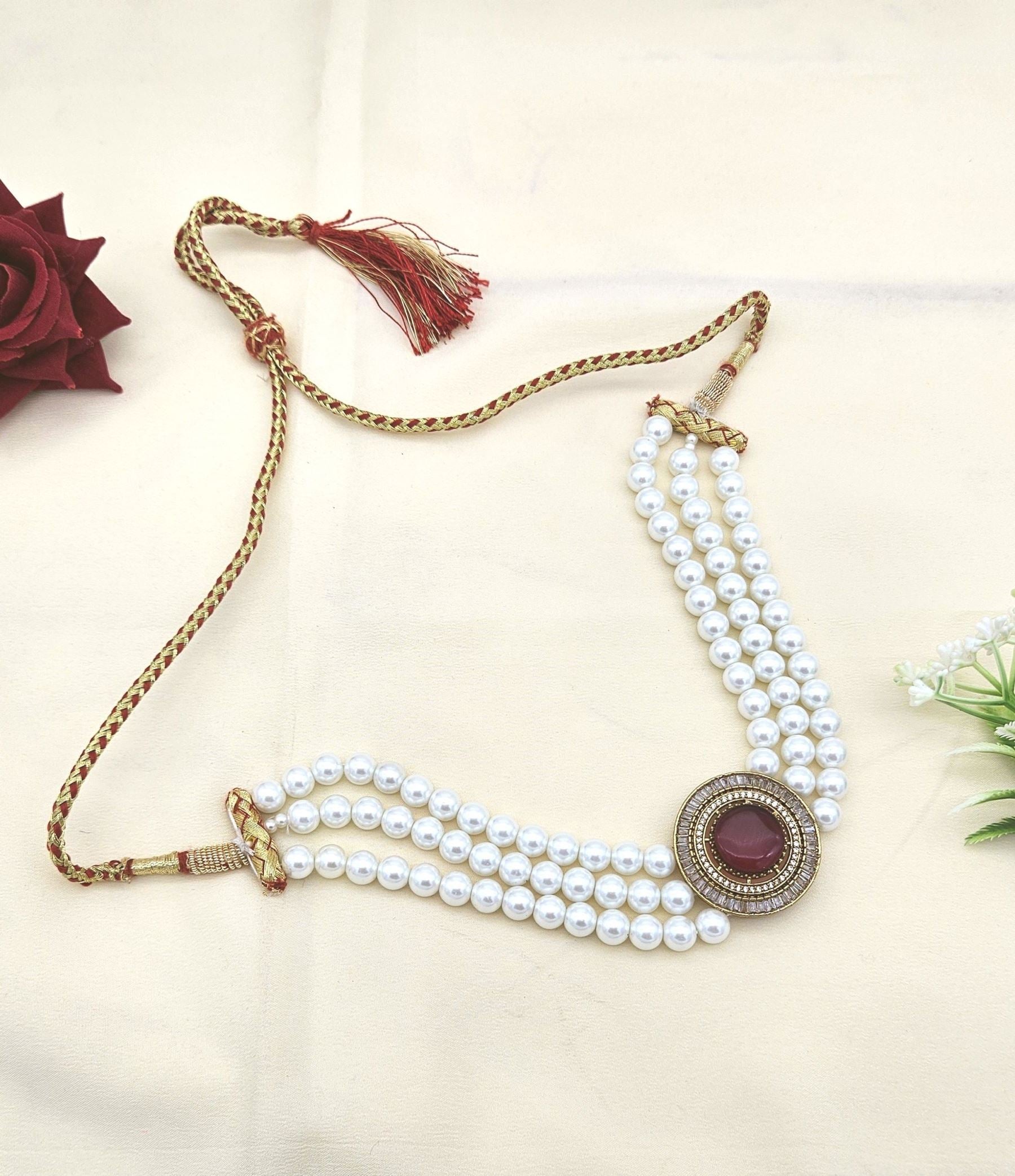 Designer antique choker necklace with AD shine, red synthetic stones, and soft pearl highlights
