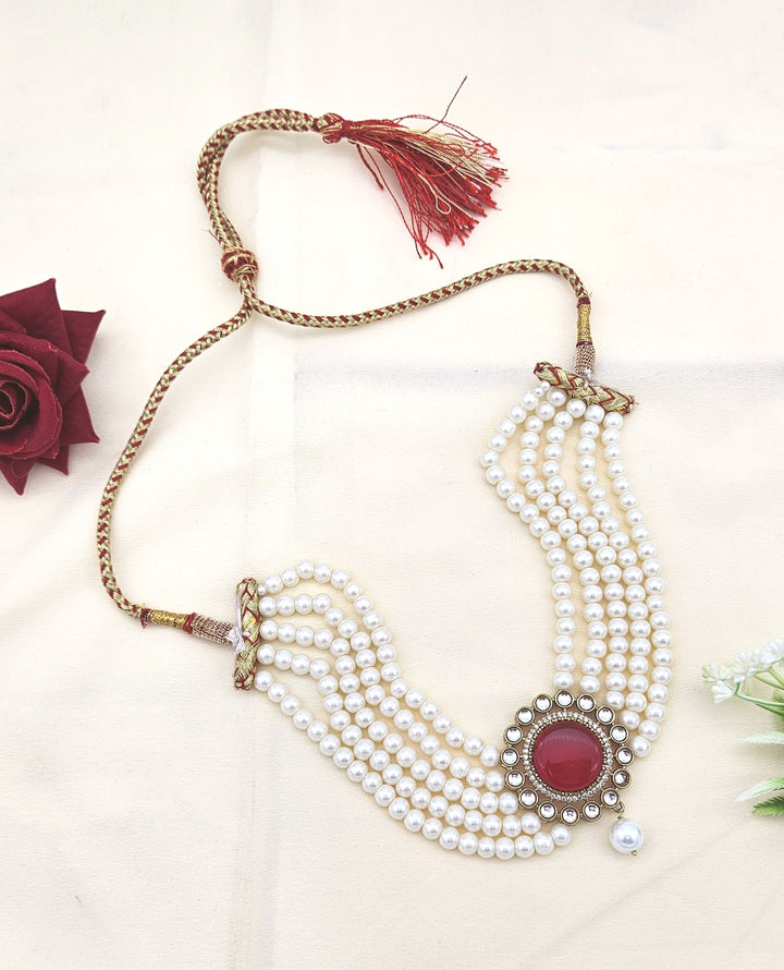 Designer choker necklace with synthetic Polky, AD sparkle, red stone accents, and classic pearl drops
