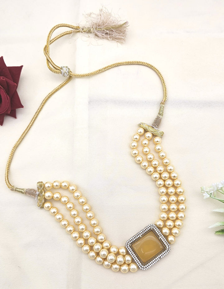 Festive wear gold choker necklace with American diamonds, yellow Monalisa stones, and pearl highlights
