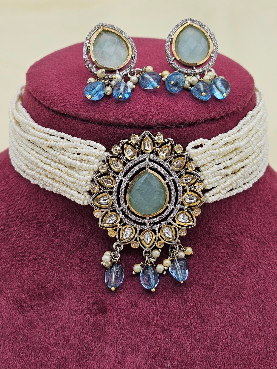 Detailed view of AD Polky and Monalisa stone choker necklace with pearl accents in antique gold finish

