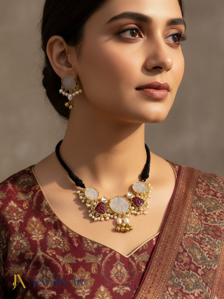 Antique gold plated necklace set with synthetic pearls red glass stones and polky work
