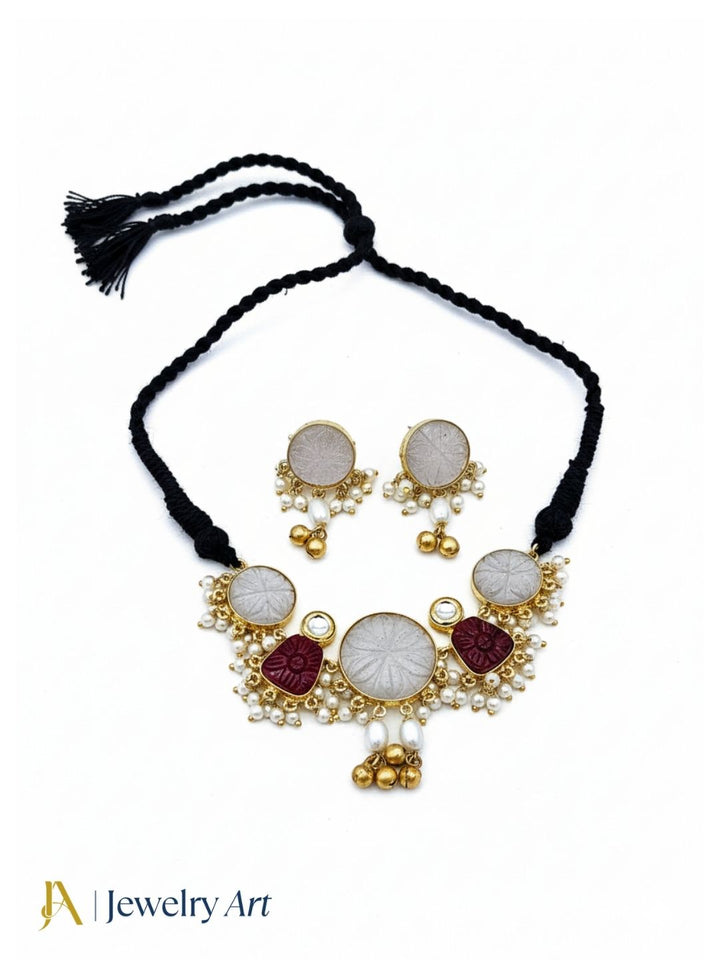 Antique gold plated necklace set with synthetic pearls red glass stones and polky work
