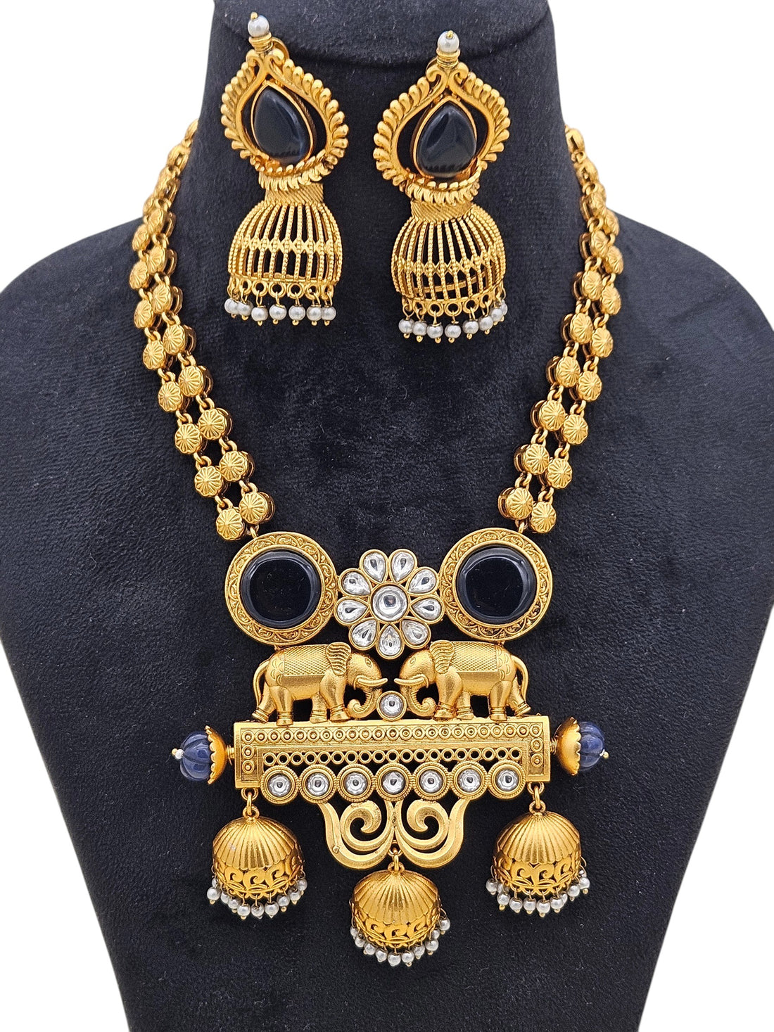 Detailed view of Polki necklace set in antique gold with blue Monalisa stones, pearls, and matching earrings

