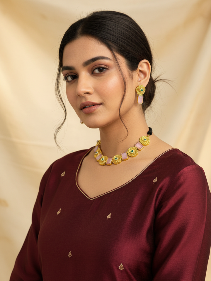 Festive antique gold plated necklace and earrings set with pink Monalisa stones worn by model