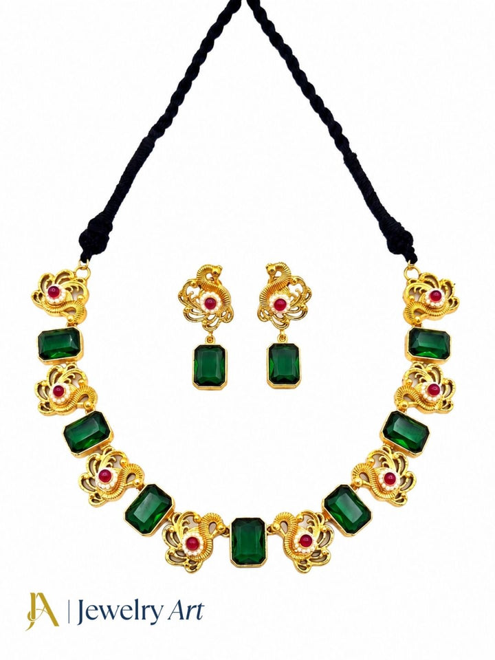 Stylish antique gold plated ethnic jewelry set with green glass stones and red glass bead embellishments
