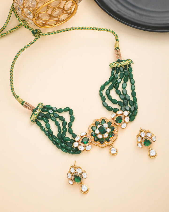 Designer broad choker necklace and earrings in antique gold with green jade and Kundan Polky stones
