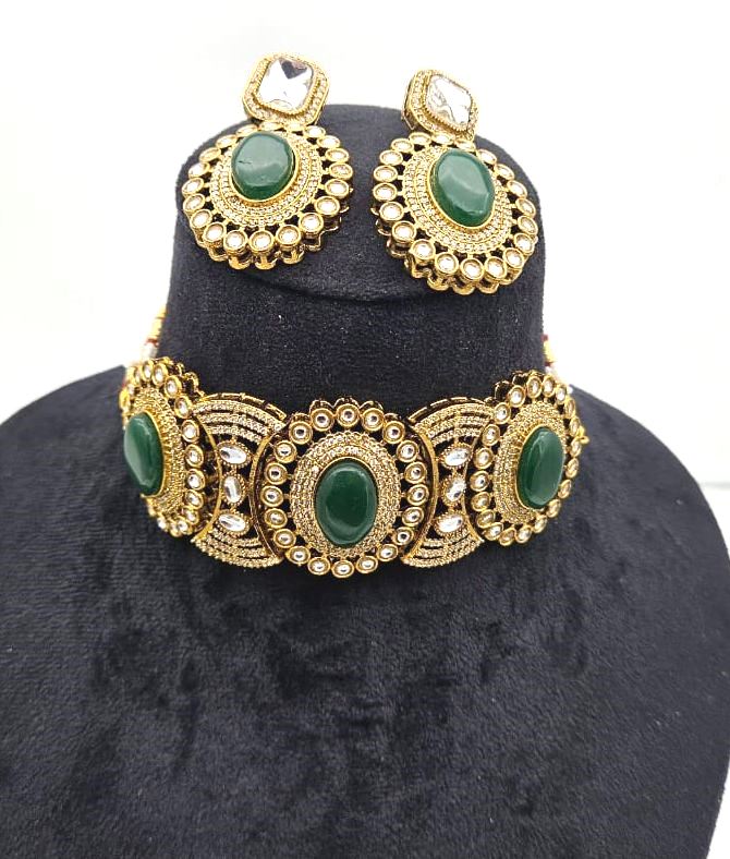 Close-up image of gold plated party wear choker set – ornate design with matching earrings for festive occasions
