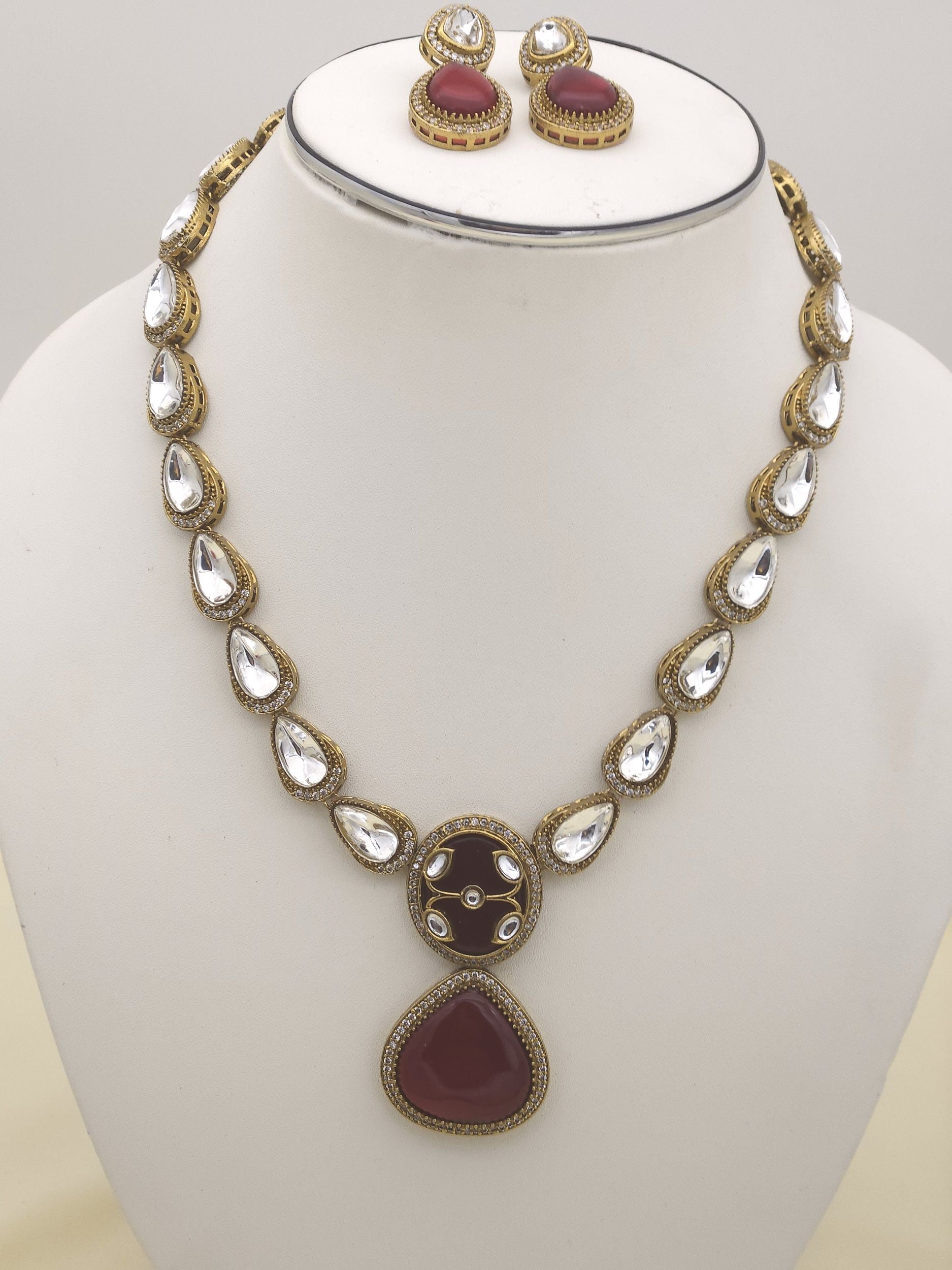 Macro shot of antique gold plated AD-Polky jewelry set highlighting luxurious texture and traditional stonework
