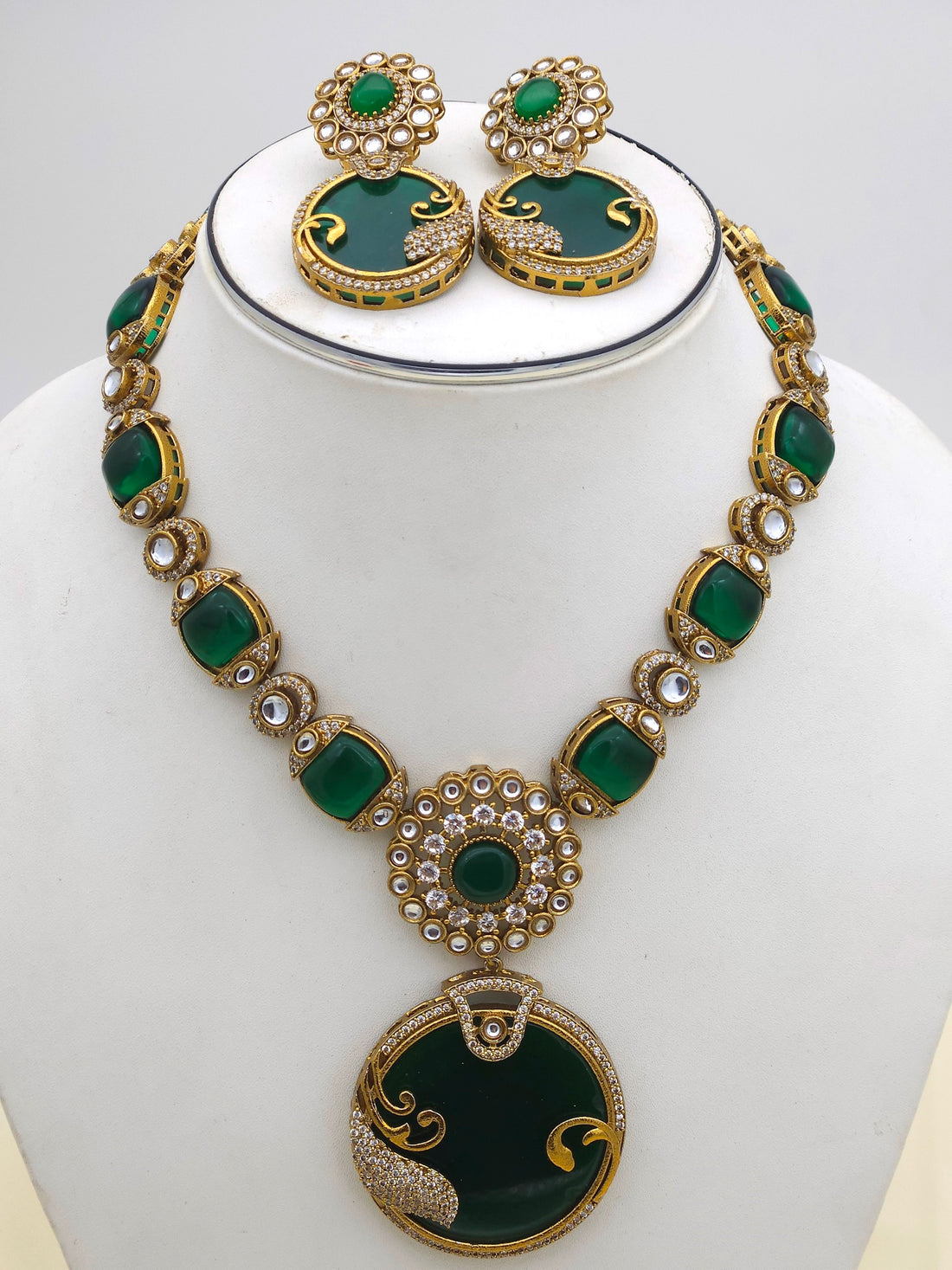 Close-up of antique gold AD-Polky necklace and earrings showcasing intricate handcrafted detailing and stonework
