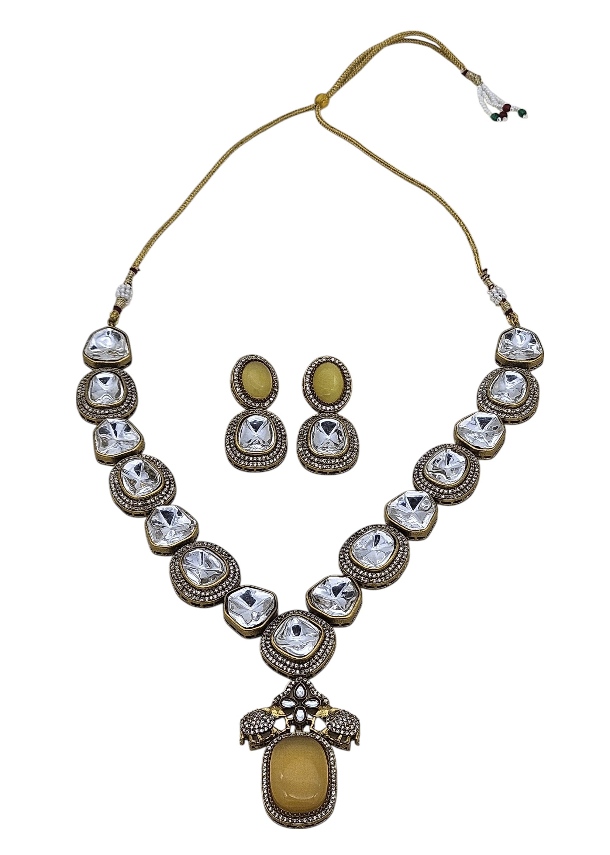 Festive designer necklace and earrings in antique gold plating, featuring exquisite Polky and American diamond stones
