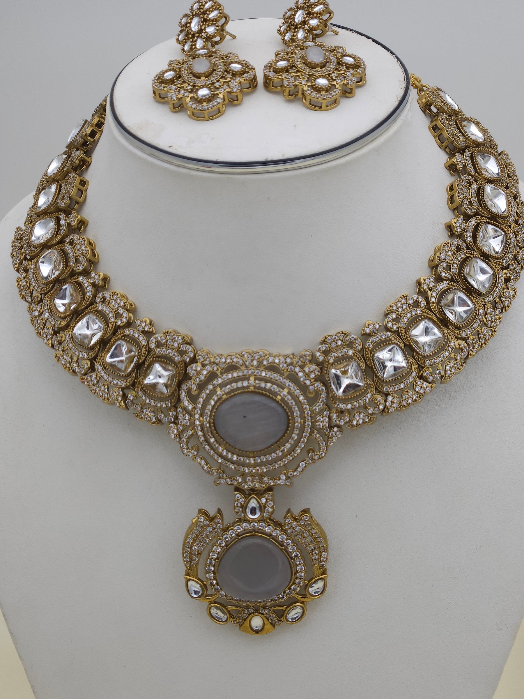 Close-up of handcrafted antique gold-plated necklace showcasing intricate Polky and sparkling AD stone detailing
