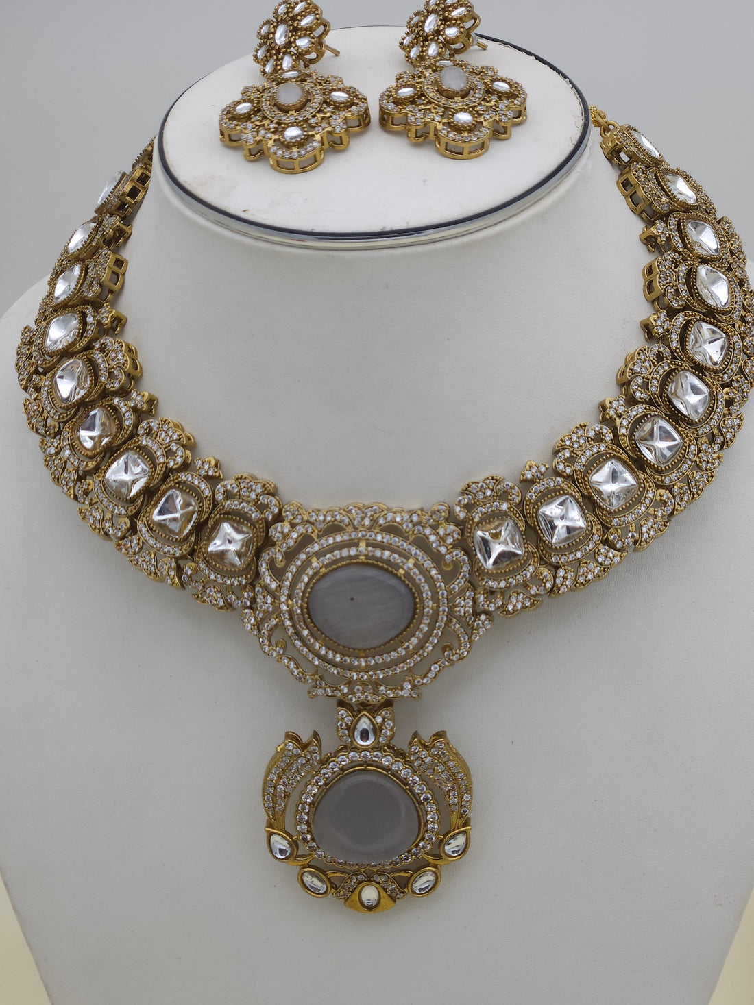 Close-up of handcrafted antique gold-plated necklace showcasing intricate Polky and sparkling AD stone detailing
