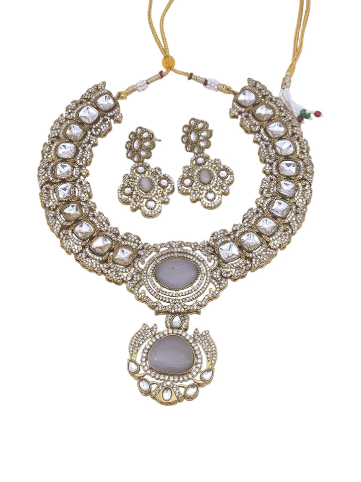 Antique finish gold necklace and earring set with sparkling AD and Polky stones, perfect for weddings and celebrations

