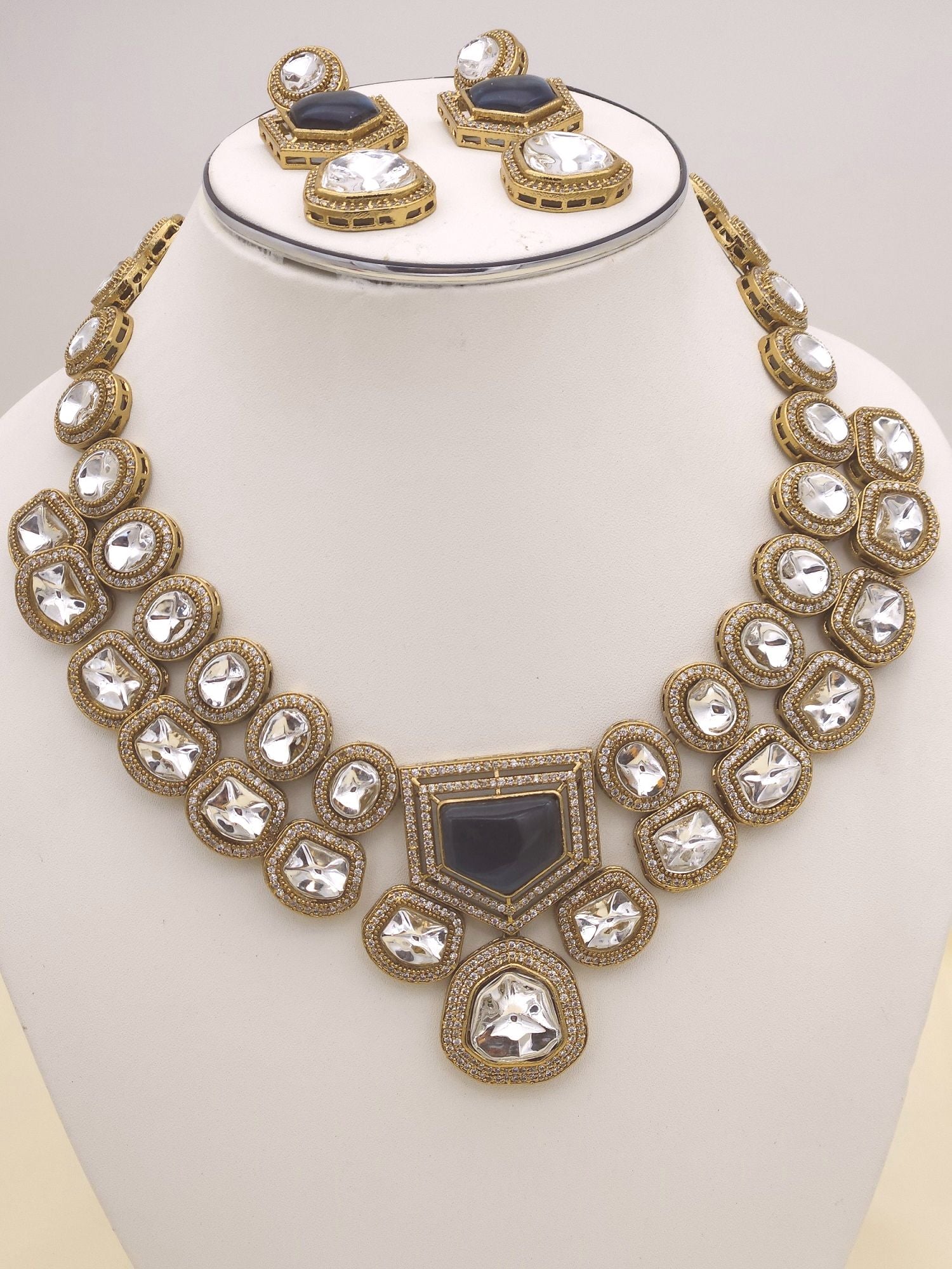 Timeless bridal jewelry in an antique gold finish, highlighted by Polky stones and AD sparkle
