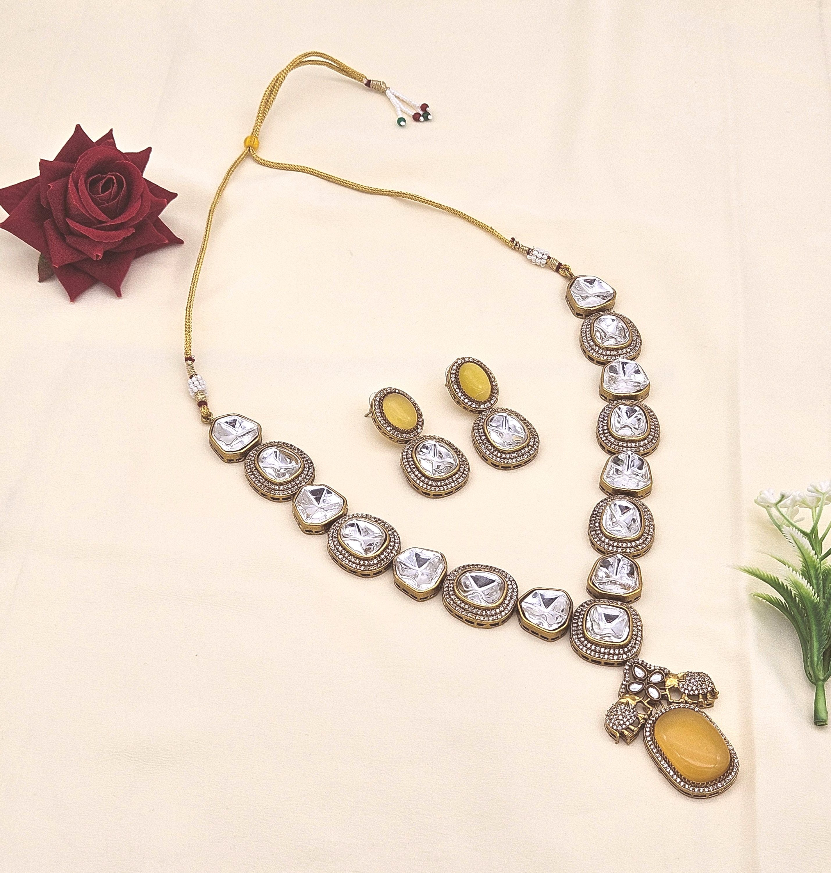 Stunning antique gold plated designer necklace and earring set with Polky and American diamond stones for festive wear
