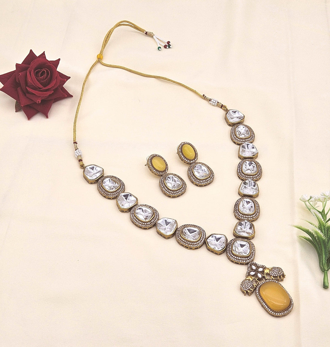 Stunning antique gold plated designer necklace and earring set with Polky and American diamond stones for festive wear

