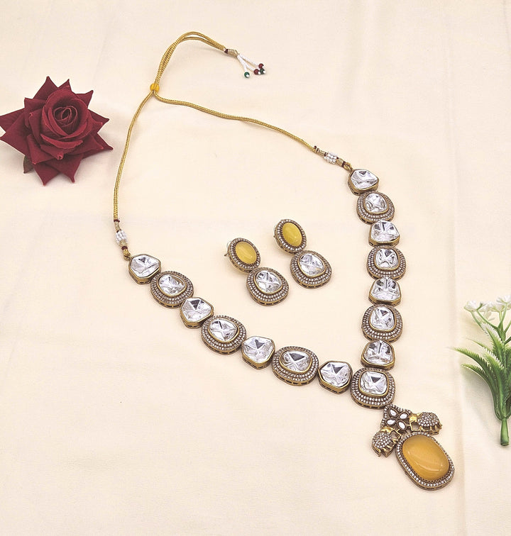 Stunning antique gold plated designer necklace and earring set with Polky and American diamond stones for festive wear
