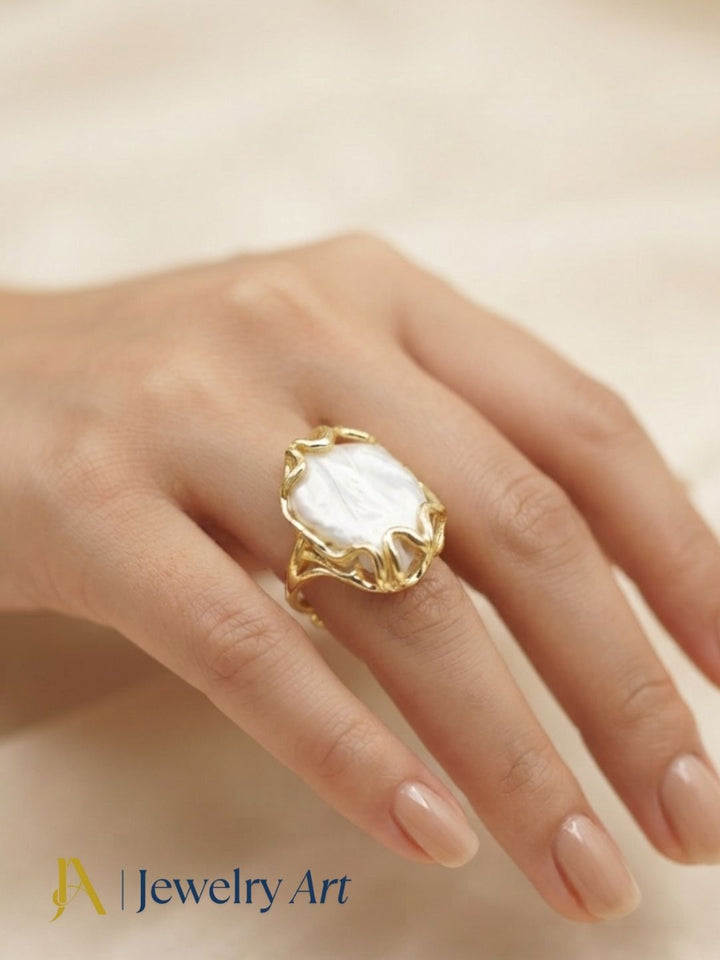 Female model wearing a handcrafted gold plated Baroque Pearl designer ring, showcasing elegant artisan craftsmanship with modern fashion styling.
