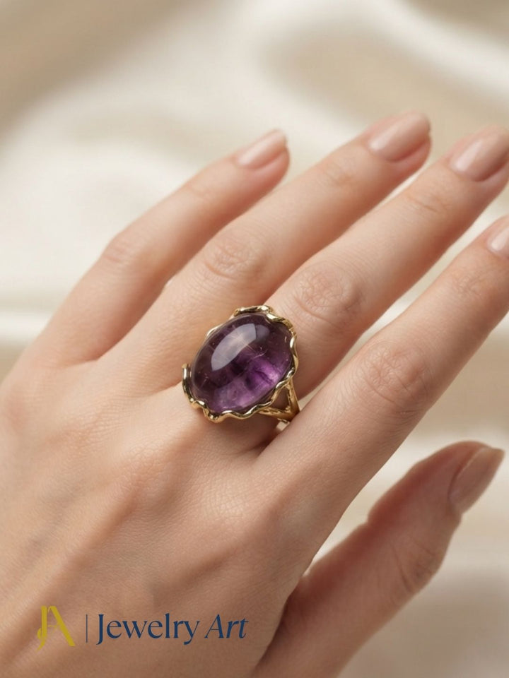 Fashion model showcasing a handcrafted Amethyst gemstone gold plated designer ring with a sophisticated contemporary look.
