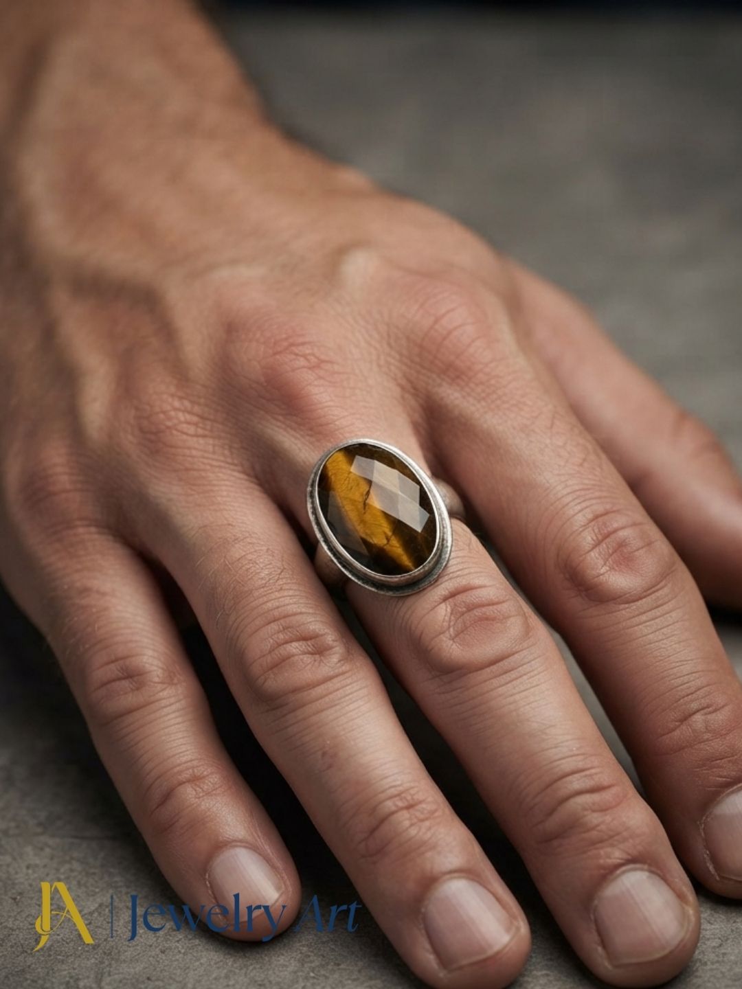 Stylish man wearing a handcrafted Tiger Eye gemstone ring in silver plated GS for a premium fashion jewelry shoot.
