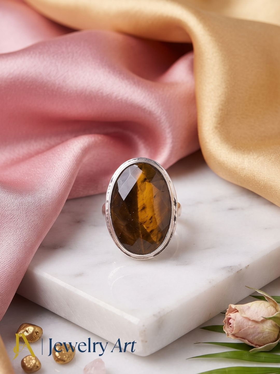 Elegant decorative arrangement highlighting a handcrafted Tiger Eye gemstone ring with a silver plated GS finish.
