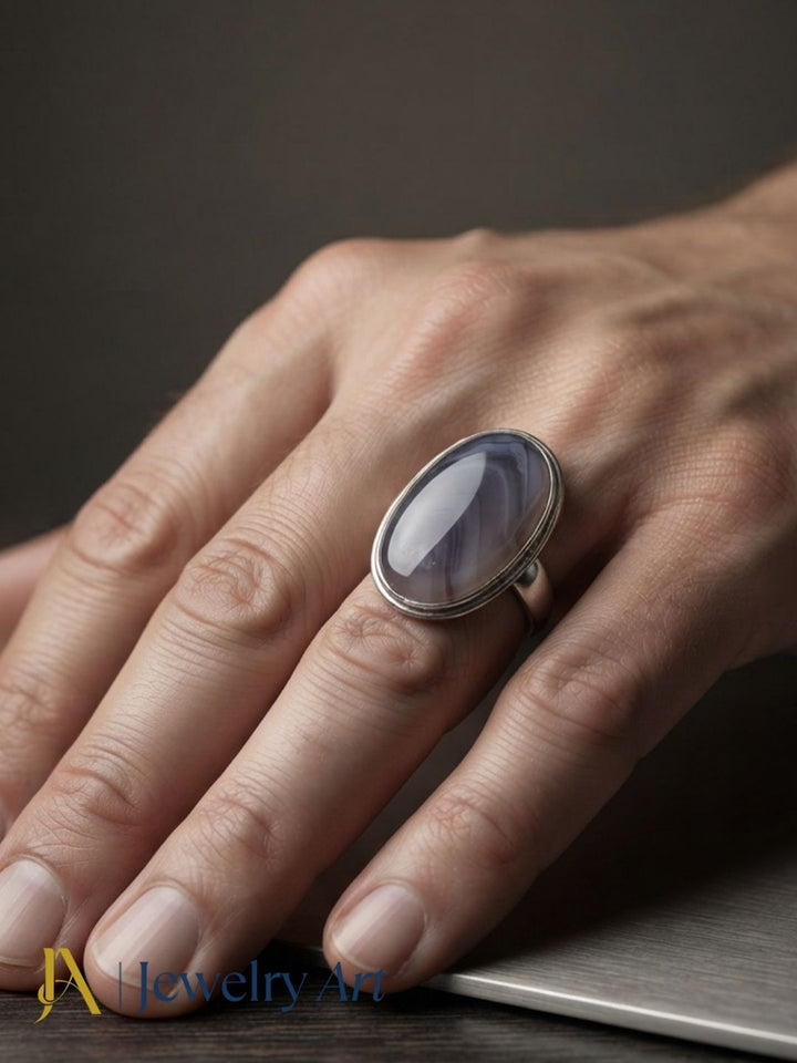 Male model wearing a handmade silver plated GS Agate stone statement ring, showcasing the natural gemstone and artisan craftsmanship with an elegant, contemporary fashion look.
