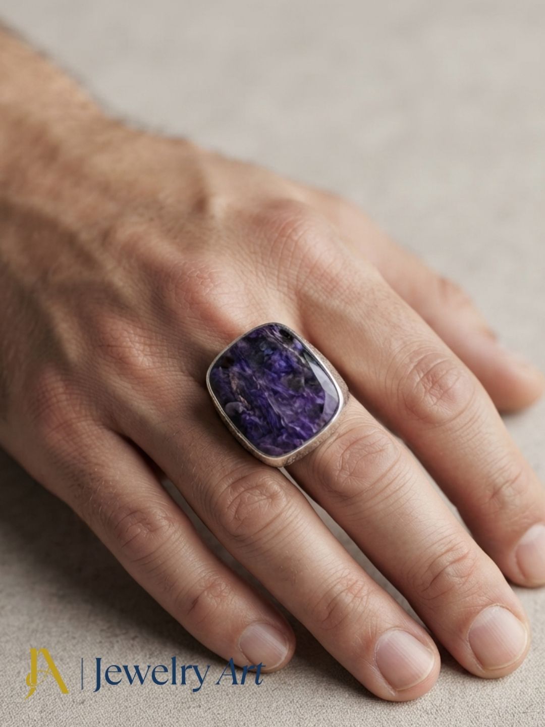 Close-up of a man's hand wearing a natural Charoite gemstone silver plated GS ring showcasing artisan craftsmanship and elegant design.
