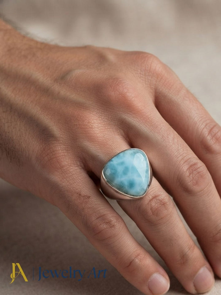Fashion model showcasing a natural Larimar stone handcrafted silver plated GS designer ring.
