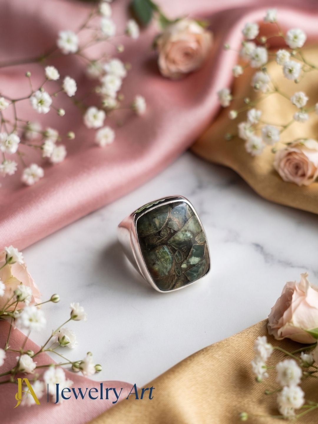 Handcrafted Copper Chrysocola gemstone ring for men in silver plated GS displayed in a luxury decorative jewelry setup with elegant props, highlighting the natural gemstone and artisan craftsmanship.
