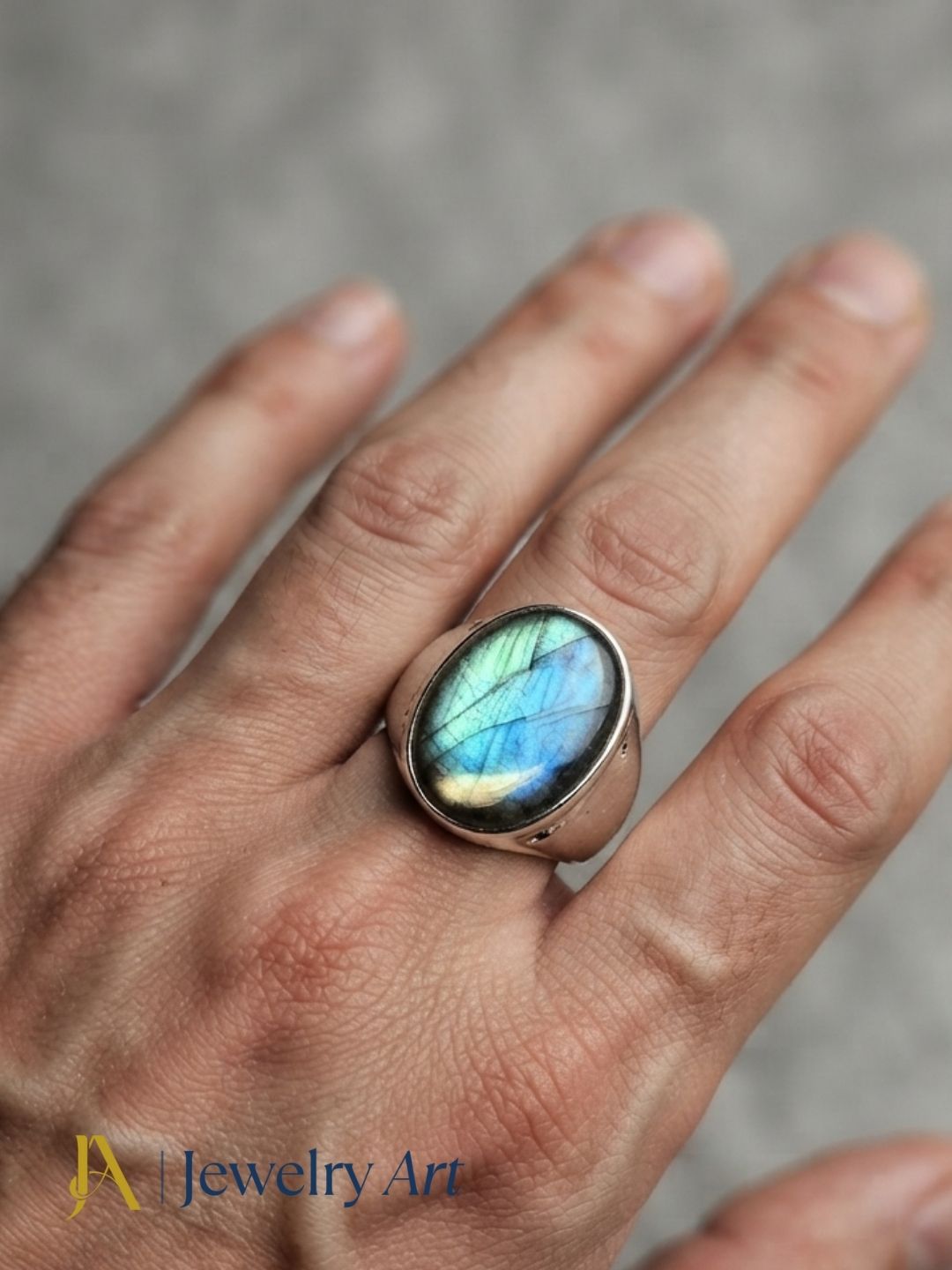 Male model wearing a handcrafted natural Labradorite gemstone silver plated GS artisan fashion ring with modern men's styling.
