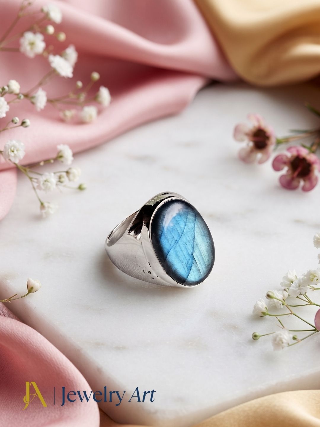 Handcrafted natural Labradorite gemstone ring for men in silver plated GS displayed in a luxury decorative jewelry setup with elegant props and premium lighting.

