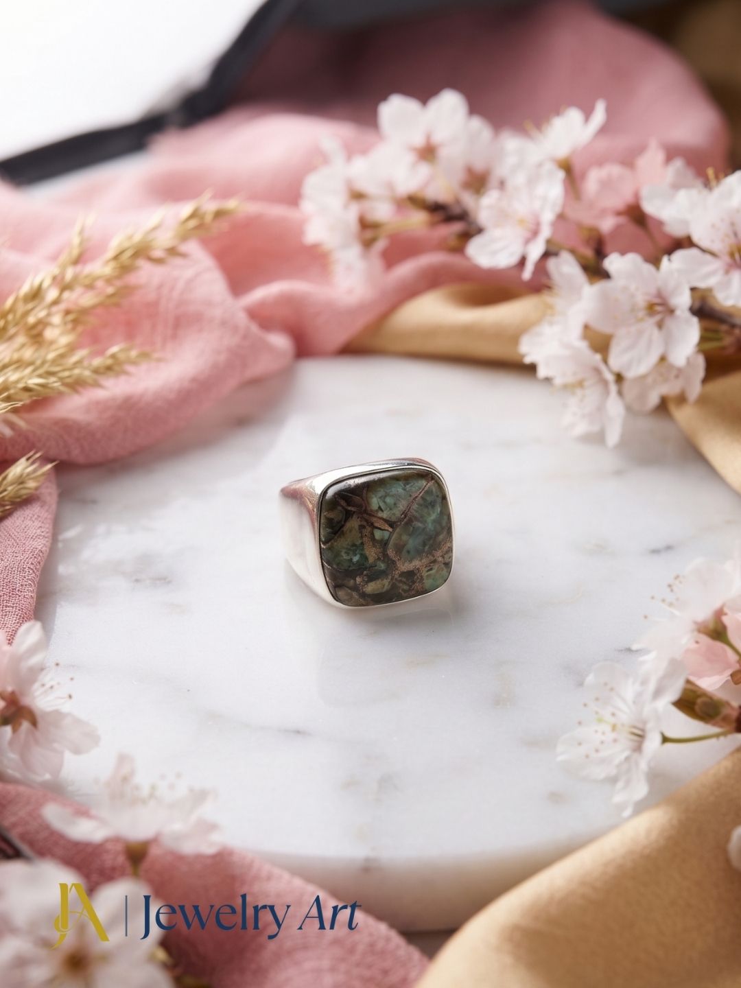 Premium Copper Chrysocola stone men's designer ring styled with elegant decorative props for luxury product photography.
