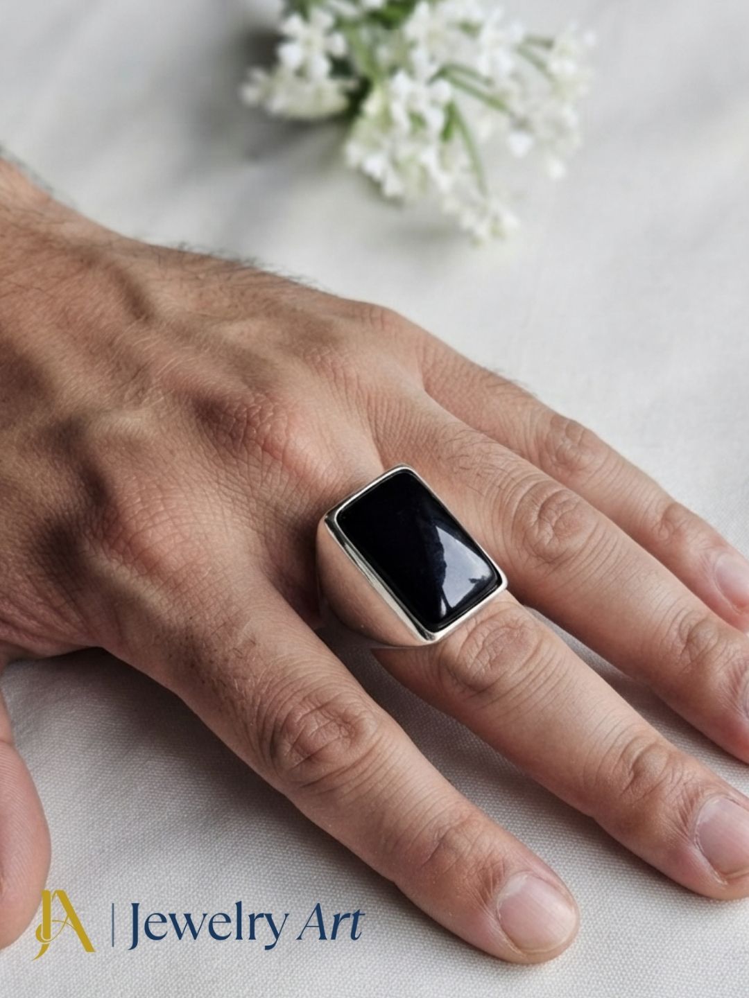 Stylish man wearing a handcrafted Amethyst gemstone ring in silver plated GS for a premium fashion jewelry photoshoot.
