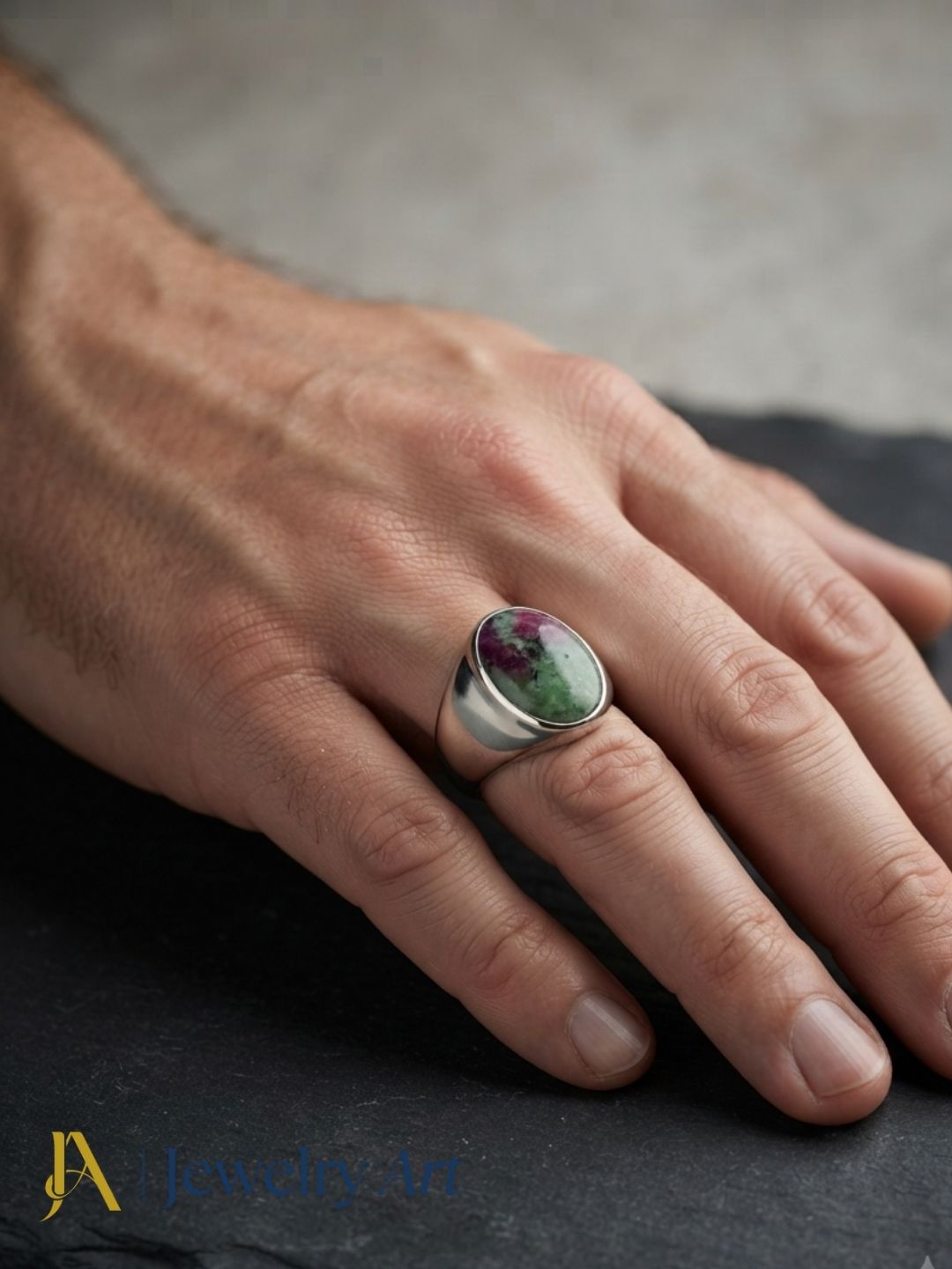 Male model wearing a handcrafted natural Ruby Zoisite stone silver plated GS designer ring with modern men's fashion styling.
