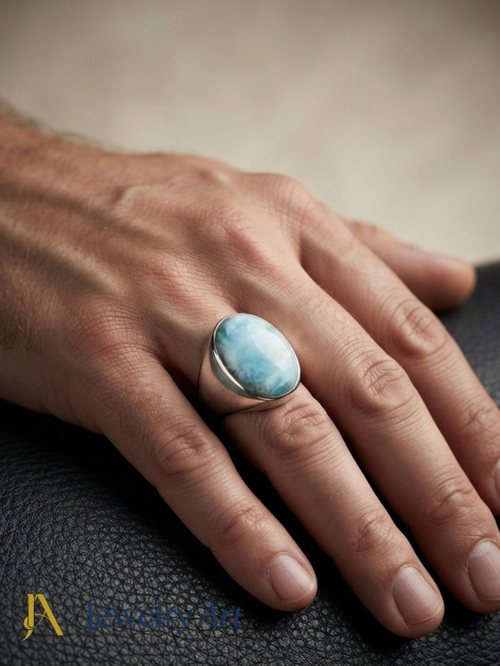 Fashion model showcasing a natural Larimar gemstone handcrafted silver plated GS statement ring with a bold contemporary look.
