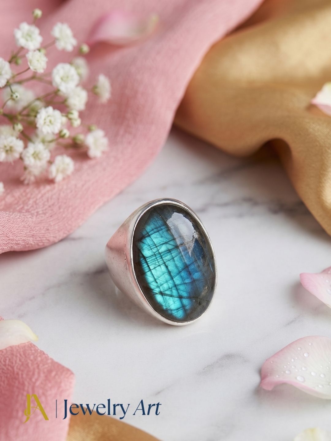 Premium Labradorite stone men's fashion ring styled with elegant decorative props for luxury product photography.

