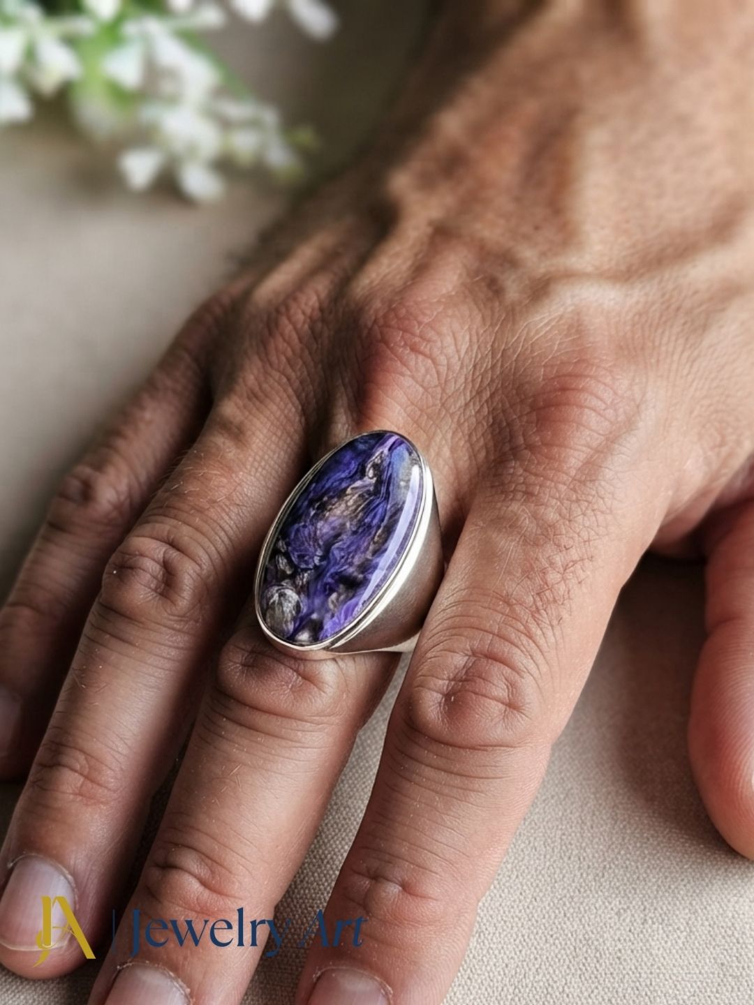 Fashion model showcasing a natural Charoite gemstone handcrafted silver plated GS designer statement ring with a contemporary look.
