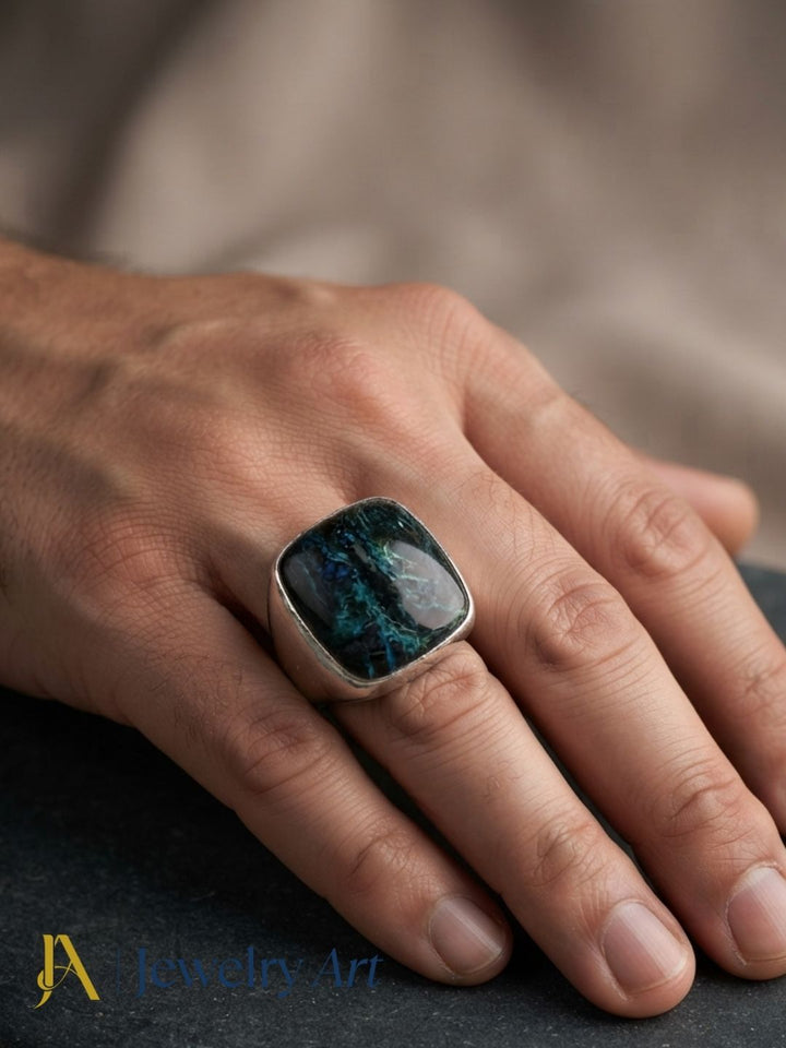 Elegant portrait of a man wearing a handcrafted Picture Jasper stone silver plated GS ring.
