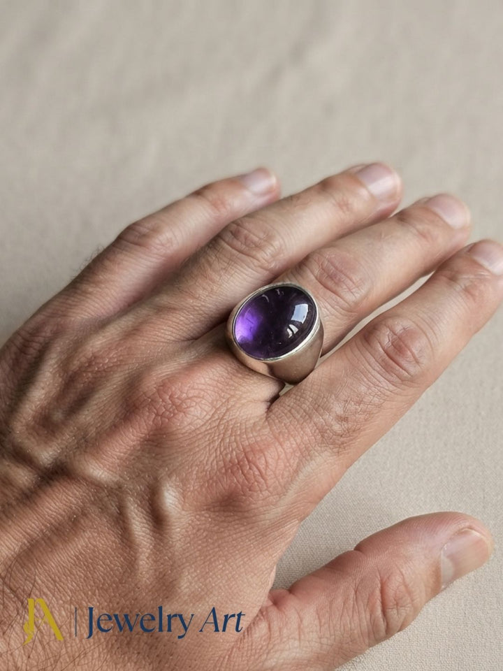 Male model wearing an artisan Amethyst gemstone silver plated GS designer statement ring, showcasing premium handcrafted craftsmanship with modern men's fashion styling.
