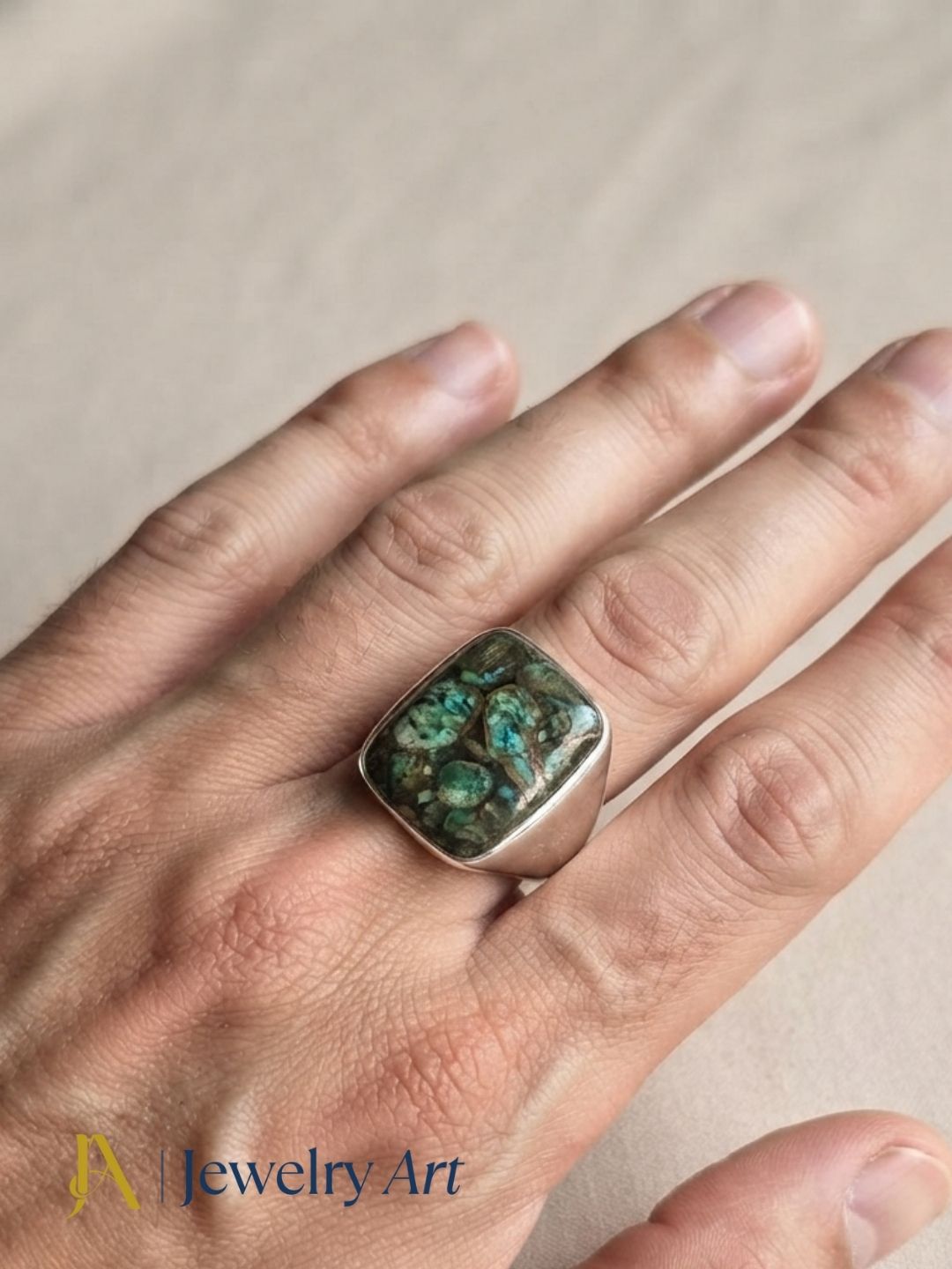 Fashion model showcasing a natural Copper Chrysocola gemstone handmade silver plated GS designer ring with a contemporary look.

