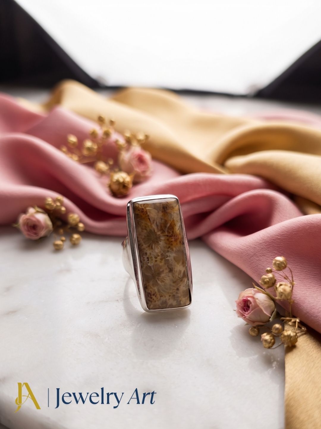 Designer Natural Fossil Coral gemstone Silver Overlay GS ring showcased in a sophisticated decorative display highlighting artisan craftsmanship.
