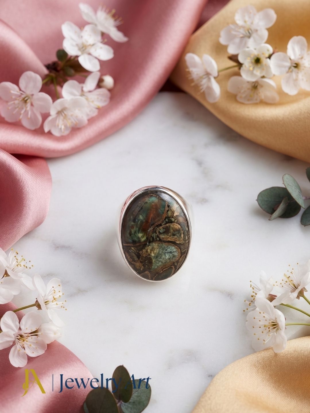 Luxury flat lay featuring a handmade natural Copper Chrysocola gemstone designer ring for men with elegant presentation.
