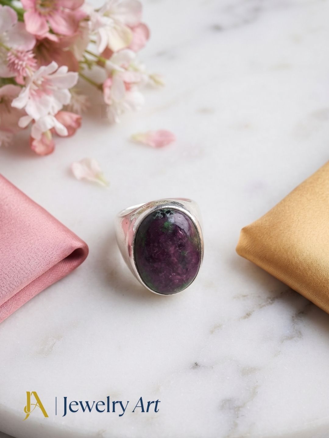 Handcrafted natural Ruby Zoisite gemstone ring for men in Silver Overlay GS displayed in a luxury decorative jewelry setup with elegant props and premium lighting.
