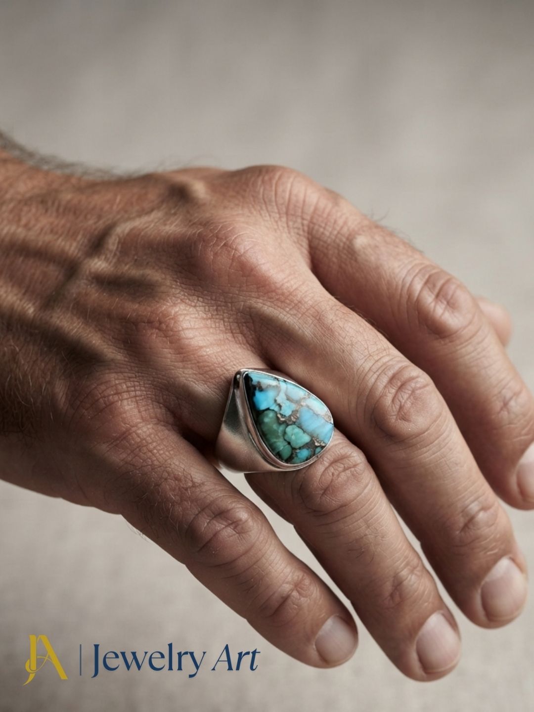 Close-up of a man's hand wearing a natural Copper Turquoise gemstone Silver Overlay GS ring showcasing artisan craftsmanship and elegant design.
