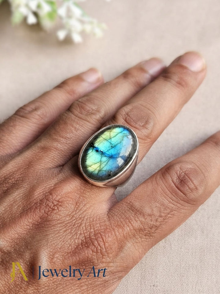Luxury men's jewelry featuring a handcrafted natural Labradorite gemstone ring with silver plated GS finish and premium craftsmanship.
