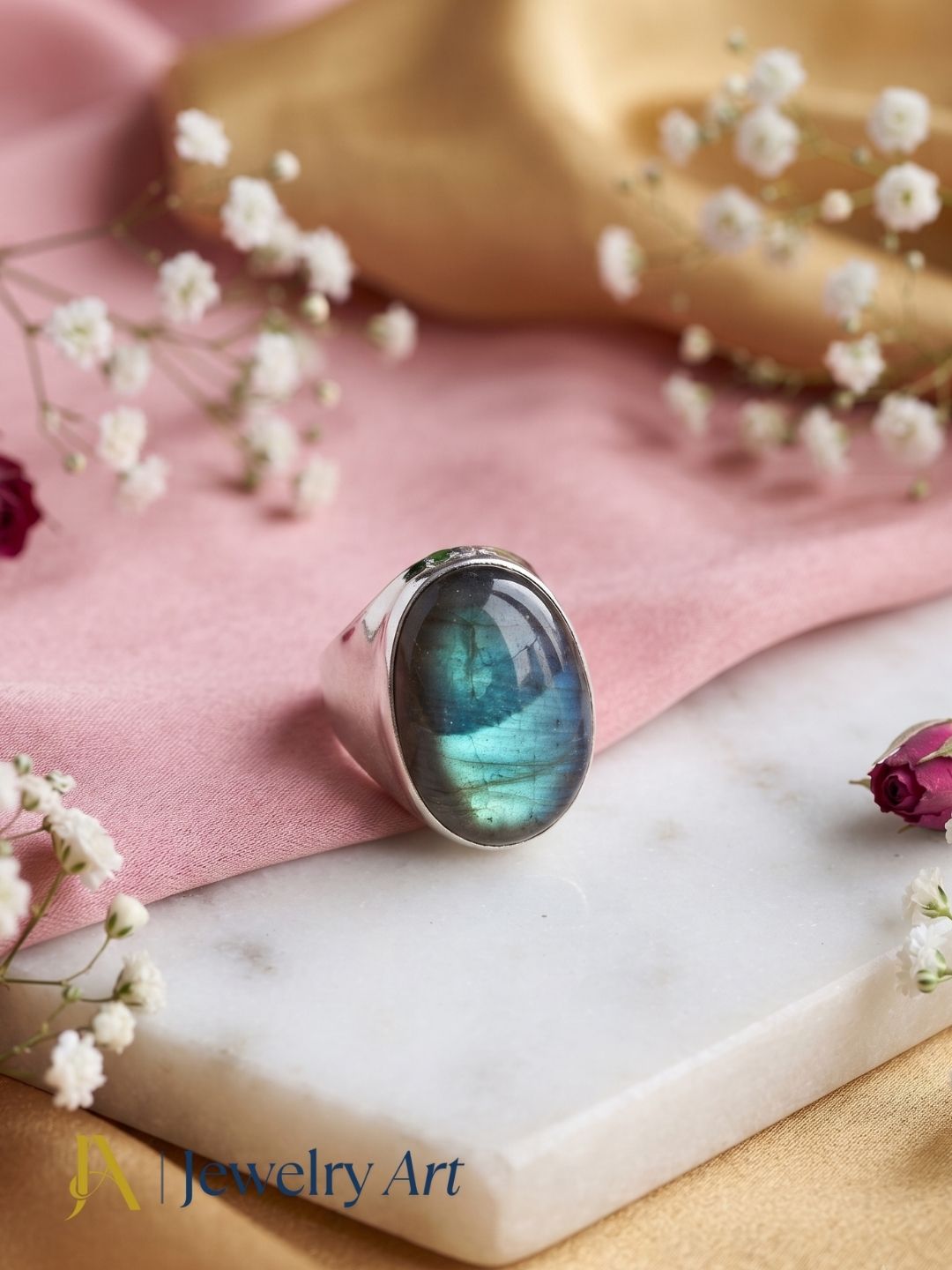 Creative jewelry styling showcasing a silver plated GS Labradorite gemstone ring with elegant decorative elements.
