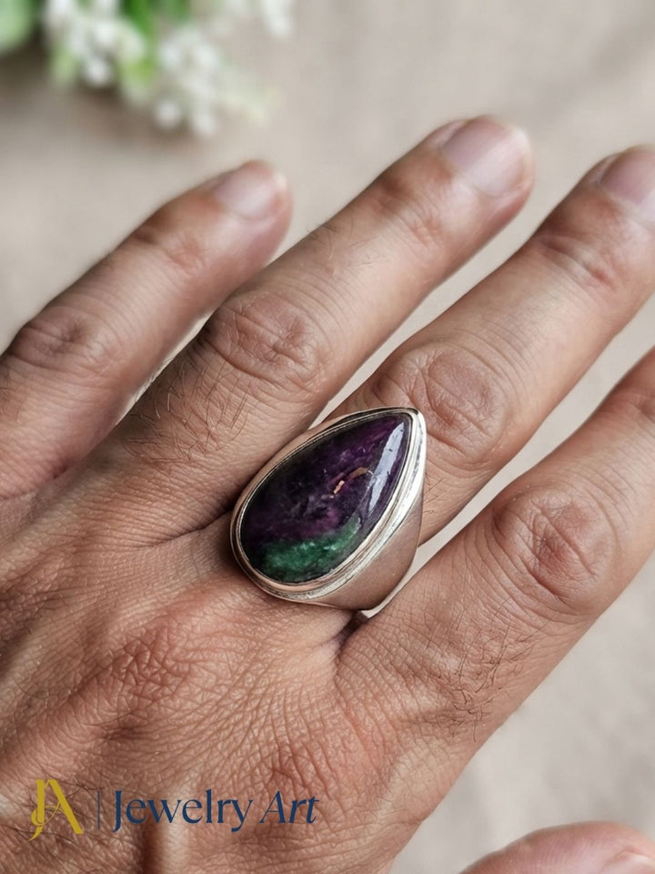 Stylish man wearing a handcrafted Ruby Zoisite stone ring in silver plated GS for a premium men's fashion jewelry photoshoot.

