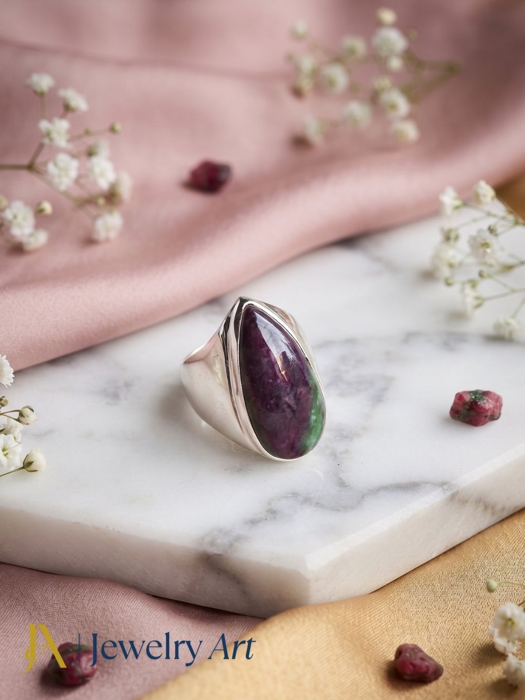Luxury flat lay featuring a handcrafted Ruby Zoisite gemstone statement ring for men with elegant presentation.
